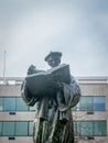 Ancient statue of a priest alone reading