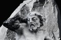 Ancient statue of Sisyphus with stone. God Zeus punished Sisyphus: he had to roll very big stone to top of high mountain rock,