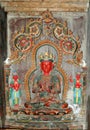 An ancient statue of a Tibetan deity with a red face