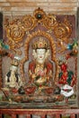 Ancient statue of a Tibetan deity with three heads of white color, a monastery