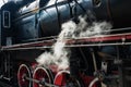 Ancient steam locomotive in steam. Live steam around mechanical Royalty Free Stock Photo
