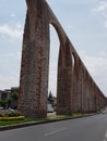 ancient stone aqueduct with columns and arches in the main avenue of the city of Queretaro