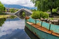 Ancient stone arch bridge and lotus pond in Dali Park, Yunnan Province, China Royalty Free Stock Photo