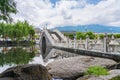 Ancient stone arch bridge and lotus pond in Dali Park, Yunnan Province, China Royalty Free Stock Photo