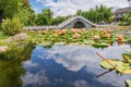 Ancient stone arch bridge and lotus pond in Dali Park, Yunnan Province, China Royalty Free Stock Photo