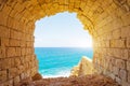 Ancient stone arch overlooking the blue tropic sea