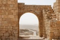 Ancient stone arch and wall with desert view durin Royalty Free Stock Photo