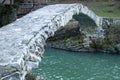 Ancient stone arched Makhuntseti, Qween Tamars Bridge, over mountain river Acharistskali , cloudy day , travek Georgia Royalty Free Stock Photo