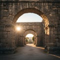 Ancient stone archways bask in the warm glow of the setting sun, illuminating the Royalty Free Stock Photo