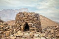 Ancient stone beehive tombs with Jebel Misht mountain in the background, archaeological site near al-Ayn, sultanate Oman