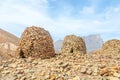 Ancient stone beehive tombs with Jebel Misht mountain in the background, archaeological site near al-Ayn, sultanate Oman