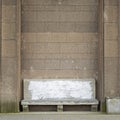 Ancient stone bench near the big brick wall Royalty Free Stock Photo