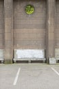 Ancient stone bench near the big brick wall Royalty Free Stock Photo