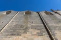 Ancient stone brick wall with gutter and clear blue sky in the b Royalty Free Stock Photo