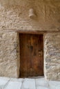 Ancient stone bricks wall and old wooden door Royalty Free Stock Photo