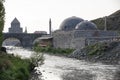 Ancient stone bridge across Kars River & Kars Castle - main tourist attractions of Kars, Turkey. Near flag on castle are portrait Royalty Free Stock Photo