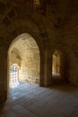 Ancient stone building with bright sunlight shining through arches Royalty Free Stock Photo