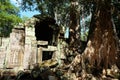 An ancient stone building with a collapsed wall. Dilapidated building of the Khmer Empire. The ruins of an ancient civilization in