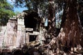 An ancient stone building with a collapsed wall. Dilapidated building of the Khmer Empire. The ruins of an ancient civilization in