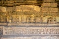 Ancient stone carvings depicting legendary animals or deities on a Dvaravati period stone wall in Si Thep Historical Park