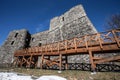 Ncient stone castle with a long wooden bridge.