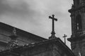 Ancient church with tower and crosses dark faded. Medieval monastery details black and white. Mystical exterior of cathedral. Royalty Free Stock Photo