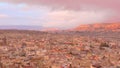 Ancient stone city on background of mountains at sunset. Action. Top view of slum stone houses in ancient city in