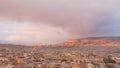 Ancient stone city on background of mountains at sunset. Action. Top view of slum stone houses in ancient city in