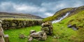 Ancient stone construction and waterfall panorama in Faroe Royalty Free Stock Photo