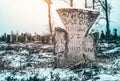 An ancient stone cross in an abandoned cemetery. History of Ukraine