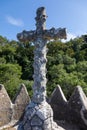 An ancient stone cross in a relict forest on the way to Cruz Alta in Bussaco Park. Coimbra. Portugal