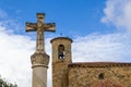 Ancient stone crucifix near a romanesque church