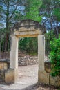 An ancient stone entrance with an inscription in Spanish to the site of the Roman aqueduct in Tarragona spain