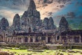 Ancient stone faces at sunset of Bayon temple, Angkor Wat, Siam Reap, Cambodia Royalty Free Stock Photo