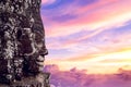 Ancient stone faces at sunset of Bayon temple, Angkor Wat.