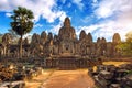 Ancient stone faces at sunset of Bayon temple, Angkor Wat.