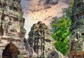 Ancient stone faces at sunset of Bayon temple, Angkor Wat, Siam Reap, Cambodia Royalty Free Stock Photo