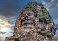 Ancient stone faces at sunset of Bayon temple, Angkor Wat, Siam Reap, Cambodia Royalty Free Stock Photo