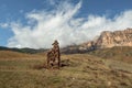 An ancient stone idol on the background of misty mountains. Tombstones made of stone. Stur-Digora region. North Ossetia