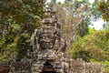 Ancient stone ruin of Banteay Kdei temple, Angkor Wat, Cambodia. Ancient temple with Buddha face on tower