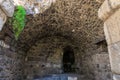 Ancient stone ruins with arched ceiling and greenery. Authentic ancient Smyrna ruins in Izmir, Turkey Royalty Free Stock Photo