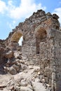 Ancient stone ruins, wall with arches against the sky