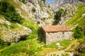 The ancient stone shed with a tile roof in mountains