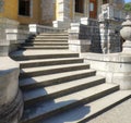 Ancient stone staircase in three marches with wide concrete steps