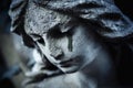 Ancient stone statue of crying sad angel with tears in face as symbol of death and end of human life Royalty Free Stock Photo