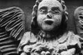 Ancient stone statue of  little guards angel. Fragment. Close up Royalty Free Stock Photo