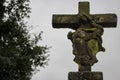 Ancient stone statue with ruined virgin mary and jesus christ figures.Old cross with Mother of God and dying jesus figures. Royalty Free Stock Photo