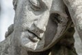 Ancient stone statue of sad man on tomb as a symbol of death, depression, pain and sorrow Royalty Free Stock Photo