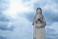 Ancient stone  statue of Virgin Mary against blue sky Royalty Free Stock Photo