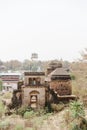 Ancient stone structure surrounded by trees and shrubs in Orchha Fort in India Royalty Free Stock Photo